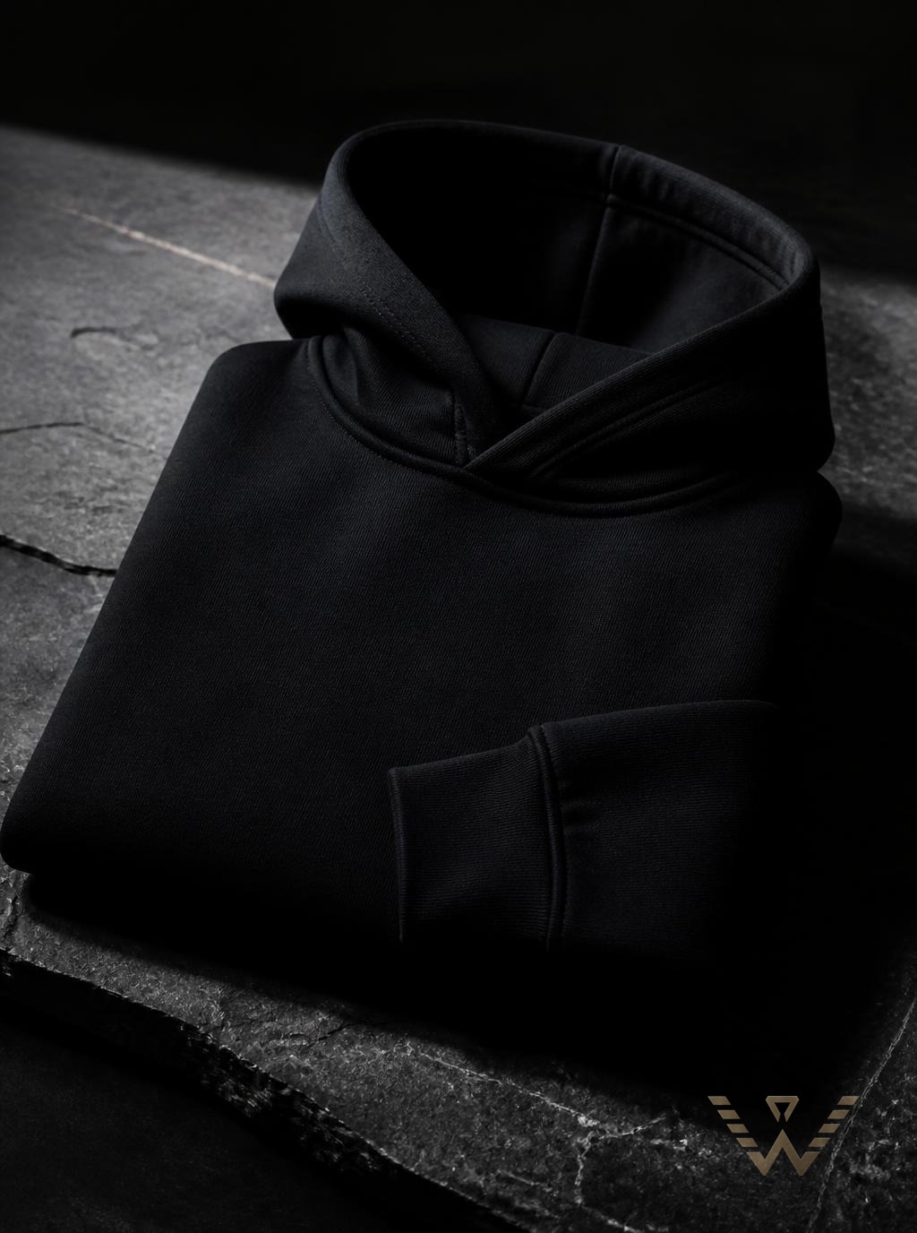 Obsidian heavyweight hoodie folded on stone